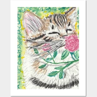 Kitten smelling flower Posters and Art